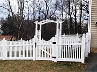 <b>Scalloped white vinyl picket fence with ball post caps</b>